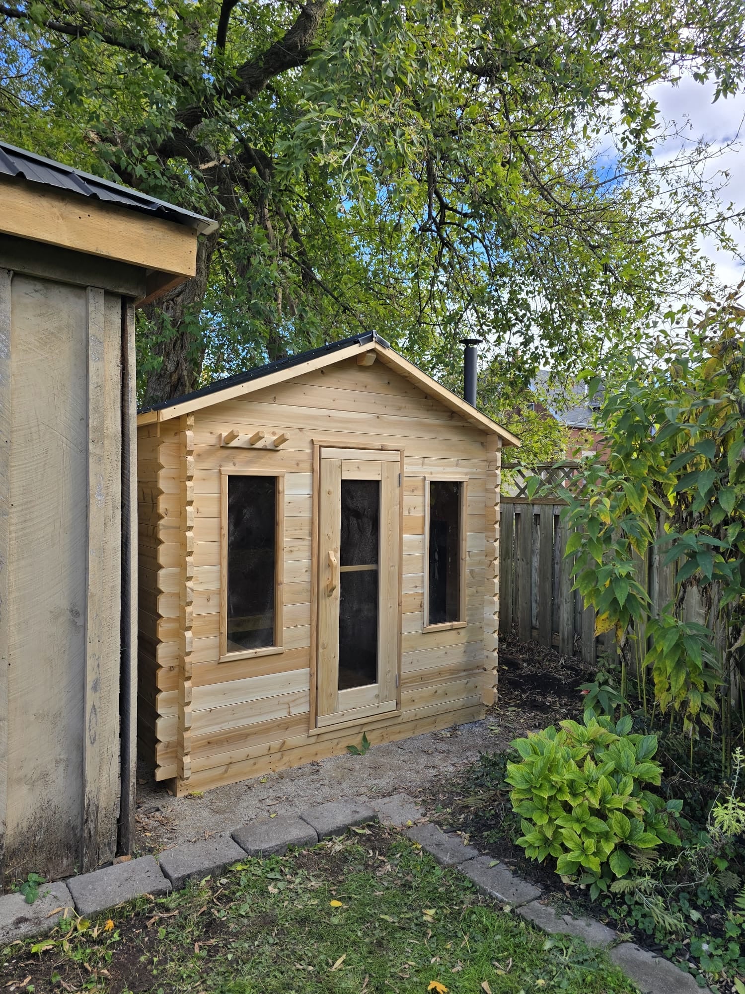 Wooden cabin sauna with a wood heater in a natural setting