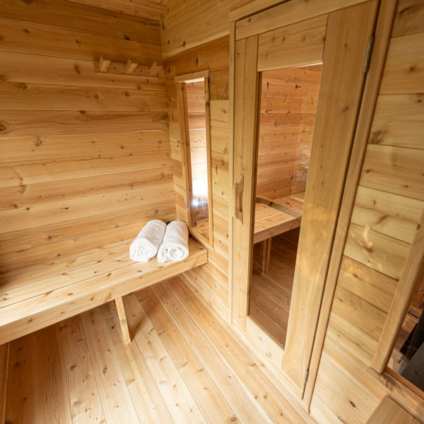 Wooden sauna with benches and towels inside changeroom