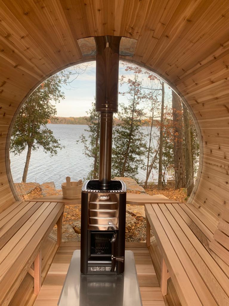 red cedar barrel sauna with panoramic lake view