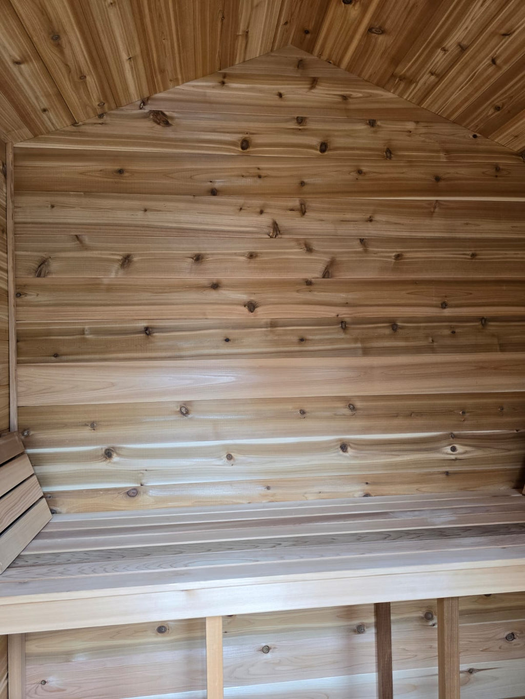 Wooden interior with a bench and ceiling