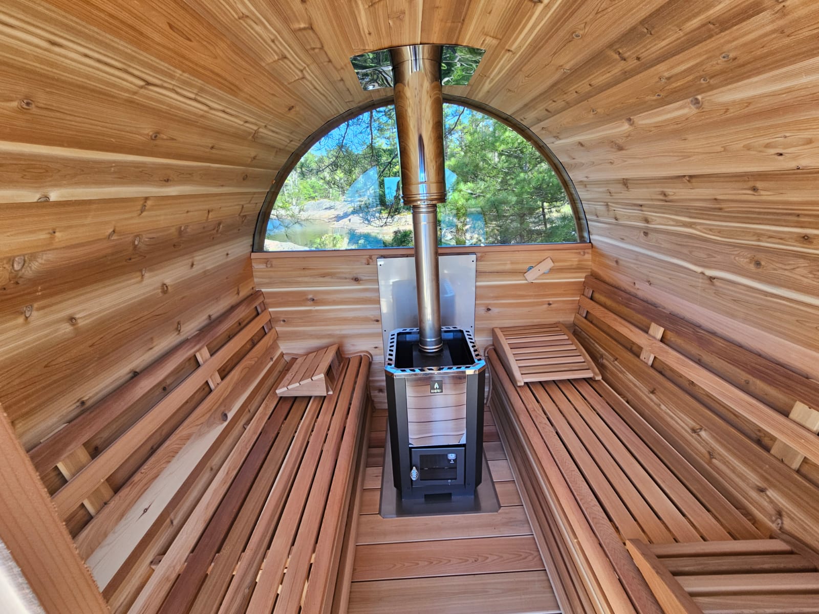 red cedar barrel sauna with wood heater