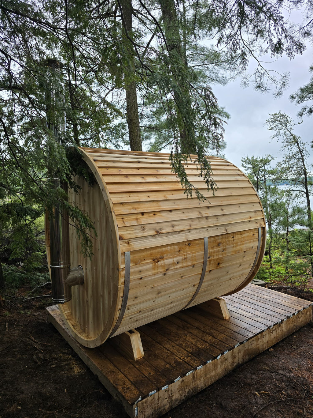Wooden barrel-shaped structure in a forest setting