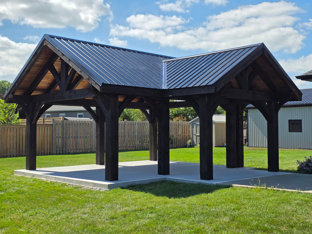 Wooden pavilion with a metal roof in a grassy area