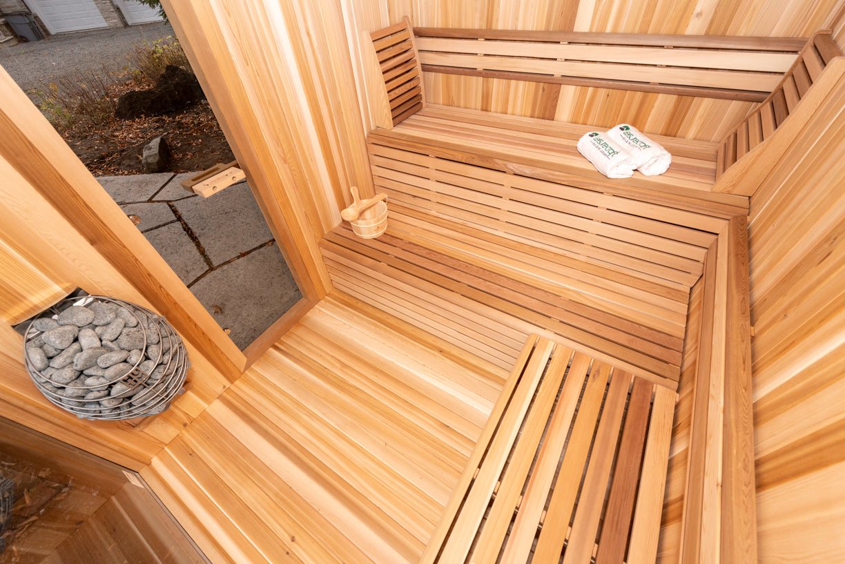Wooden sauna interior with a stone heater and towels. wifi control