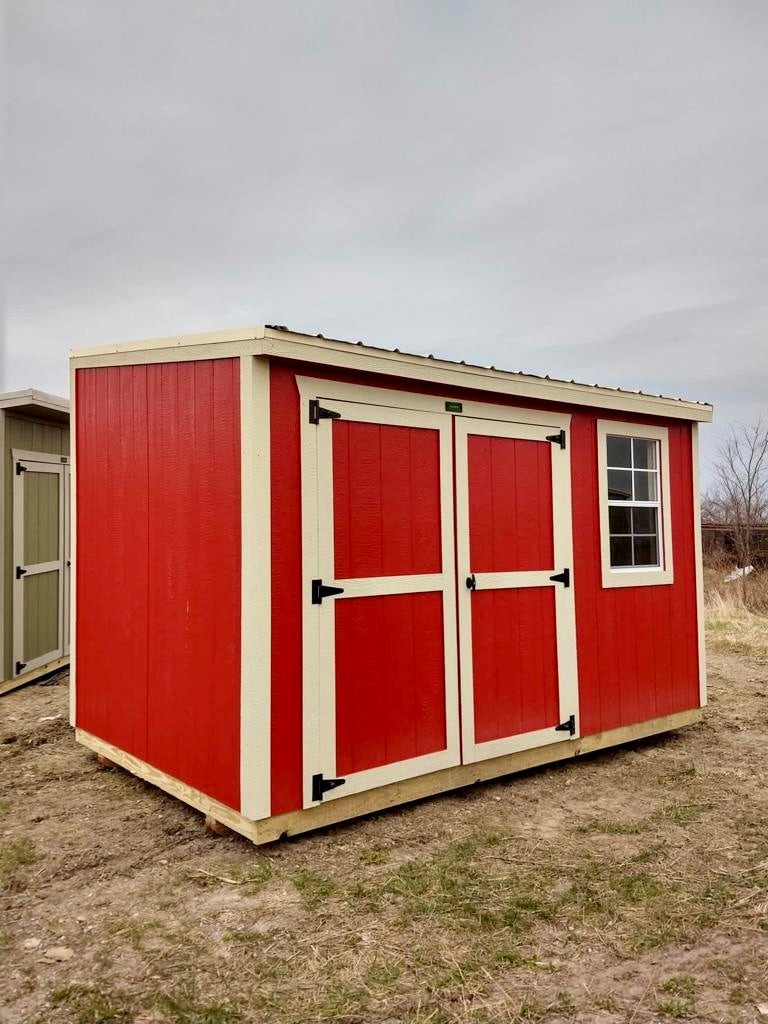 red garden shed with door and window